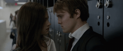 A Man And A Woman Are Looking Into Each Other 'S Eyes GIF