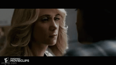 A Man And A Woman Are Looking Into Each Other 'S Eyes . GIF