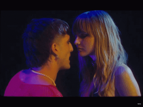 A Man And A Woman Are Looking Into Each Other 'S Eyes In A Video GIF
