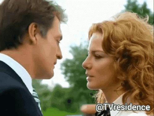 A Man And A Woman Are Looking Into Each Other 'S Eyes With The Words @Tvresidence Written Below Them GIF