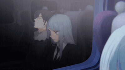 A Man And A Woman Are Looking Out A Window GIF