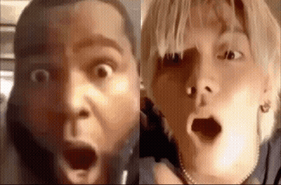 A Man And A Woman Are Making Funny Faces With Their Mouths Open . GIF
