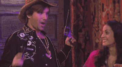 A Man And A Woman Are Making Funny Faces With Their Mouths Open GIF