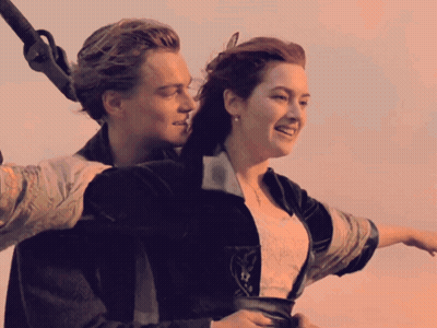 A Man And A Woman Are On A Boat And Smiling GIF