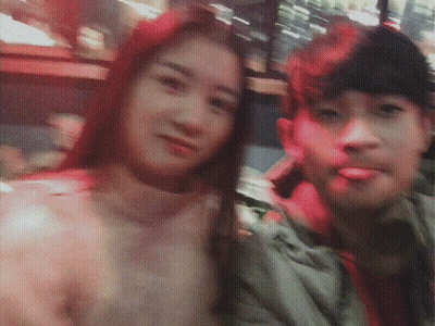 A Man And A Woman Are Posing For A Photo And The Woman Has Red Hair GIF
