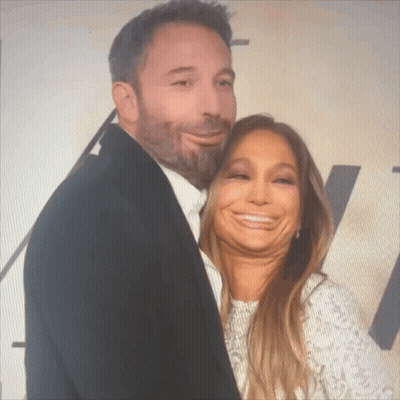 A Man And A Woman Are Posing For A Photo And The Woman Is Making A Funny Face GIF