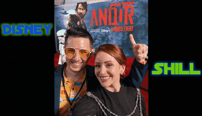 A Man And A Woman Are Posing For A Photo In Front Of A Star Wars Poster GIF