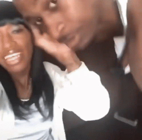 A Man And A Woman Are Posing For A Picture And The Woman Is Smiling GIF