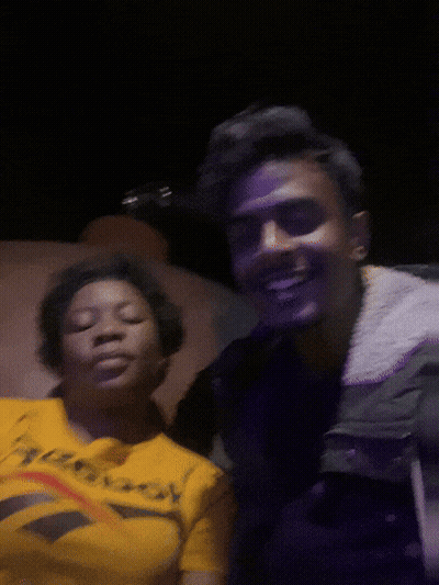 A Man And A Woman Are Posing For A Picture And The Woman Is Wearing A Reebok Shirt GIF