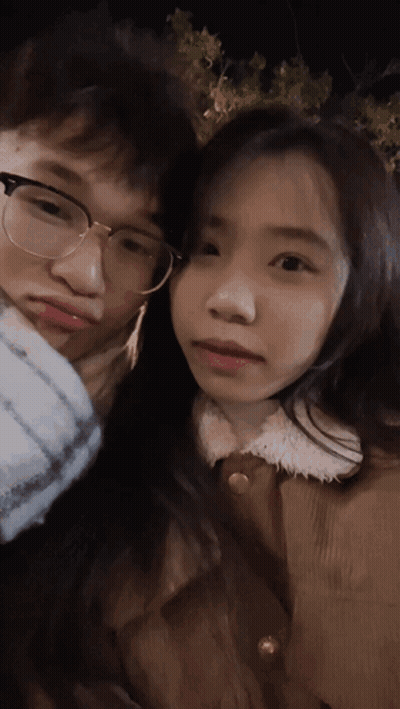 A Man And A Woman Are Posing For A Picture And The Woman Is Wearing Glasses GIF