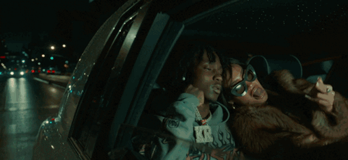 A Man And A Woman Are Posing For A Picture And The Woman Is Wearing Sunglasses GIF