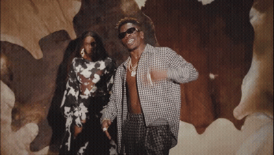 A Man And A Woman Are Posing For A Picture GIF