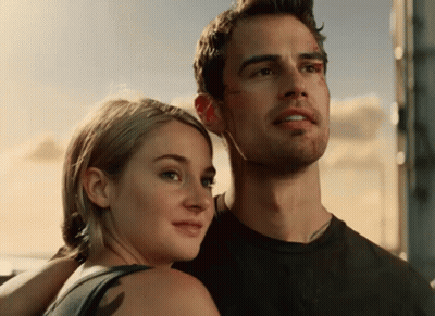 A Man And A Woman Are Posing For A Picture GIF