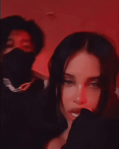 A Man And A Woman Are Posing For A Picture . The Woman Is Wearing A Black Mask . GIF