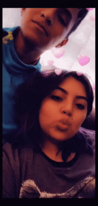A Man And A Woman Are Posing For A Picture Together GIF