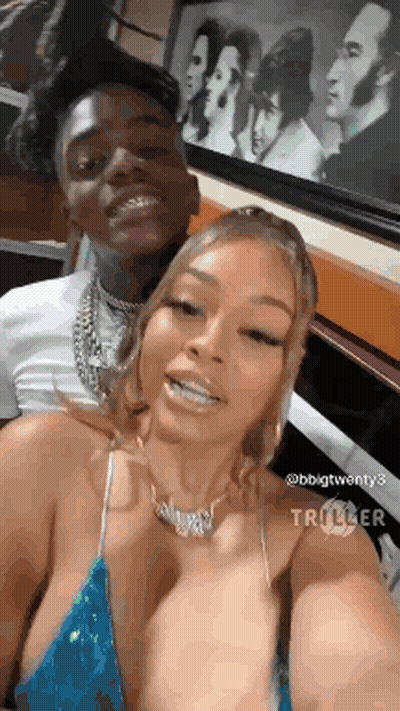 A Man And A Woman Are Posing For A Picture Together . GIF