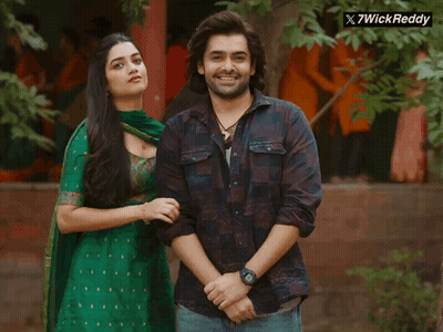 A Man And A Woman Are Posing For A Picture With A X7wick Reddy Logo In The Corner GIF