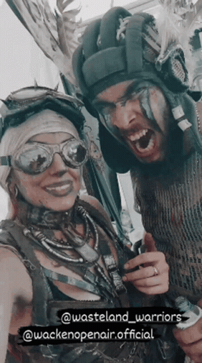 A Man And A Woman Are Posing For A Picture With The Words Wasteland Warriors At The Bottom GIF