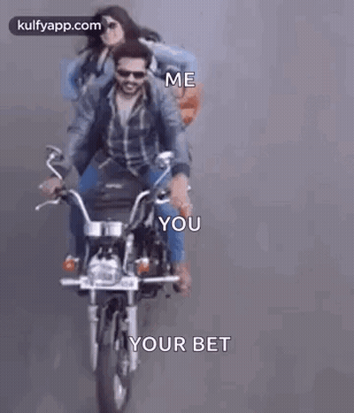 A Man And A Woman Are Riding A Motorcycle . GIF