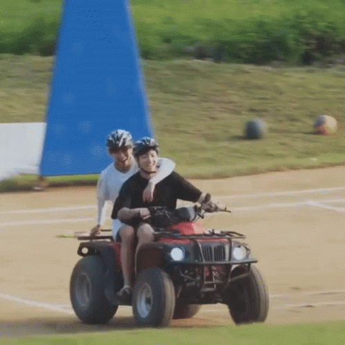 Man And Woman Riding Red ATV GIF