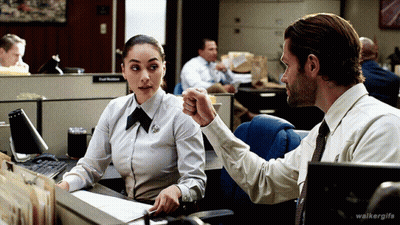 A Man And A Woman Are Sitting At A Desk With Walkergifs Written On The Bottom Right GIF