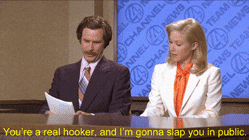 A Man And A Woman Are Sitting At A News Desk With The Words You 'Re A Real Hooker GIF