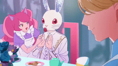 A Man And A Woman Are Sitting At A Table And The Man Has A Rabbit Mask On His Head GIF