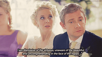 A Man And A Woman Are Sitting At A Table And The Man Is Saying " I Am Dismissive Of The Virtuous GIF