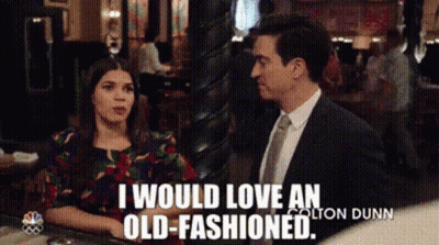 A Man And A Woman Are Sitting At A Table And The Man Is Saying I Would Love An Old-Fashioned GIF