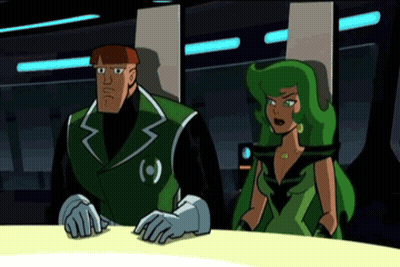 A Man And A Woman Are Sitting At A Table And The Man Is Wearing A Green Jacket With The Letter O On It GIF