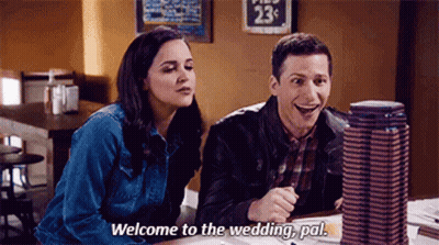 A Man And A Woman Are Sitting At A Table In A Restaurant . The Woman Is Saying `` Welcome To The Wedding , Pal '' GIF