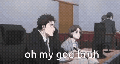 A Man And A Woman Are Sitting At A Table In Front Of A Microphone . GIF