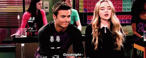 A Man And A Woman Are Sitting At A Table Talking To Each Other And The Man Is Saying Goodnight . GIF