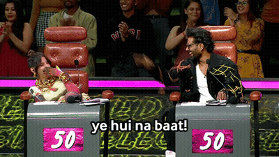 A Man And A Woman Are Sitting At A Table With 50 On It GIF