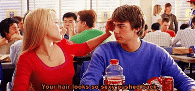 a man and a woman are sitting at a table with a coca cola bottle in front of them .