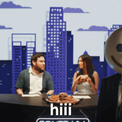 A Man And A Woman Are Sitting At A Table With A Plate Of Food That Says Hiii On It GIF
