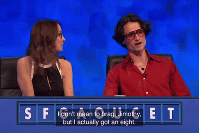 A Man And A Woman Are Sitting At A Table With A Sign That Says Judi & Joe On It GIF