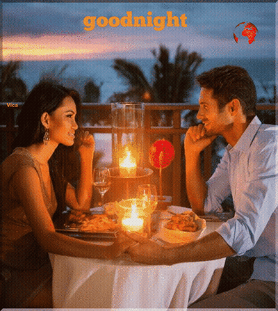 A Man And A Woman Are Sitting At A Table With Candles And The Words Goodnight Written Above Them GIF