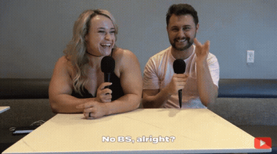 A Man And A Woman Are Sitting At A Table With Microphones And One Of Them Says No Bs Alright GIF