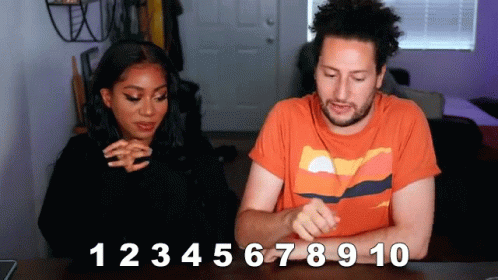 a man and a woman are sitting at a table with the numbers 1 2 3 4 5 6 7 8 9 10 written on the table