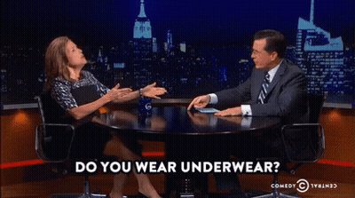 A Man And A Woman Are Sitting At A Table With The Words Do You Wear Underwear On The Bottom GIF