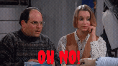 A Man And A Woman Are Sitting At A Table With The Words Oh No In Red Letters GIF