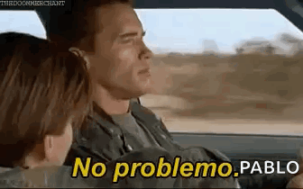 A Man And A Woman Are Sitting In A Car And The Man Is Driving . GIF