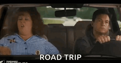 A Man And A Woman Are Sitting In A Car And The Woman Is Yawning . GIF