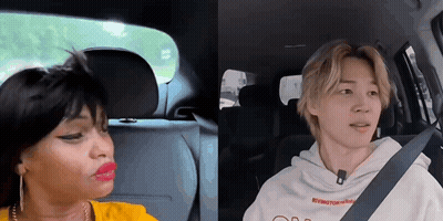 A Man And A Woman Are Sitting In A Car . GIF