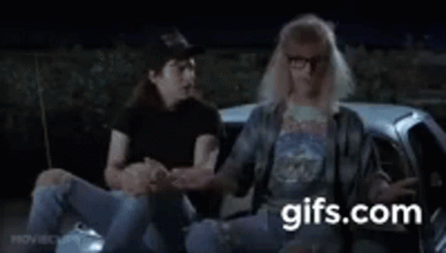 A Man And A Woman Are Sitting In A Car . GIF
