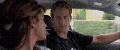 A Man And A Woman Are Sitting In A Car . GIF