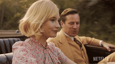 A Man And A Woman Are Sitting In A Car With Netflix Written On The Bottom Right GIF