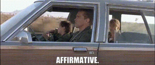A Man And A Woman Are Sitting In A Car With The Words Affirmative Written On The Bottom GIF