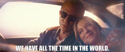 A Man And A Woman Are Sitting In A Car With The Words `` We Have All The Time In The World '' Above Them . GIF